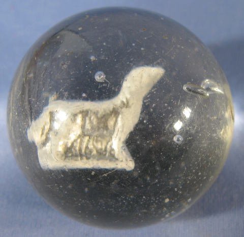 Sulphide Marble w/ a Lamb: Sulphide Marble w/ a Lamb: has 1 pontil. (It has never been ground and has a scattering of tiny nicks and rub marks. There is a dimple near the pontil with a white unmelted pebble of some kind. This w