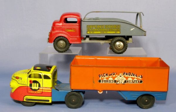 2 Toy Trucks: 1 Structo & 1 Wyandotte: 2 Toy Trucks: 1.) Structo Toyland Garage 24 Hr. Towing Truck. Made of pressed steel with red cab and gray box. 12" long (The string and hook is missing. There is some corrosion on the inside of the bo