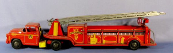 Marx V.F.D. Hook & Ladder No.9 Toy Truck: Marx V.F.D. Hook & Ladder Toy Truck No.9: the 3 section ladder extends to 57" long. The cab is numbered 76. (There are some scuffs and scrapes from use. One ladder section is not attached. The ladder 