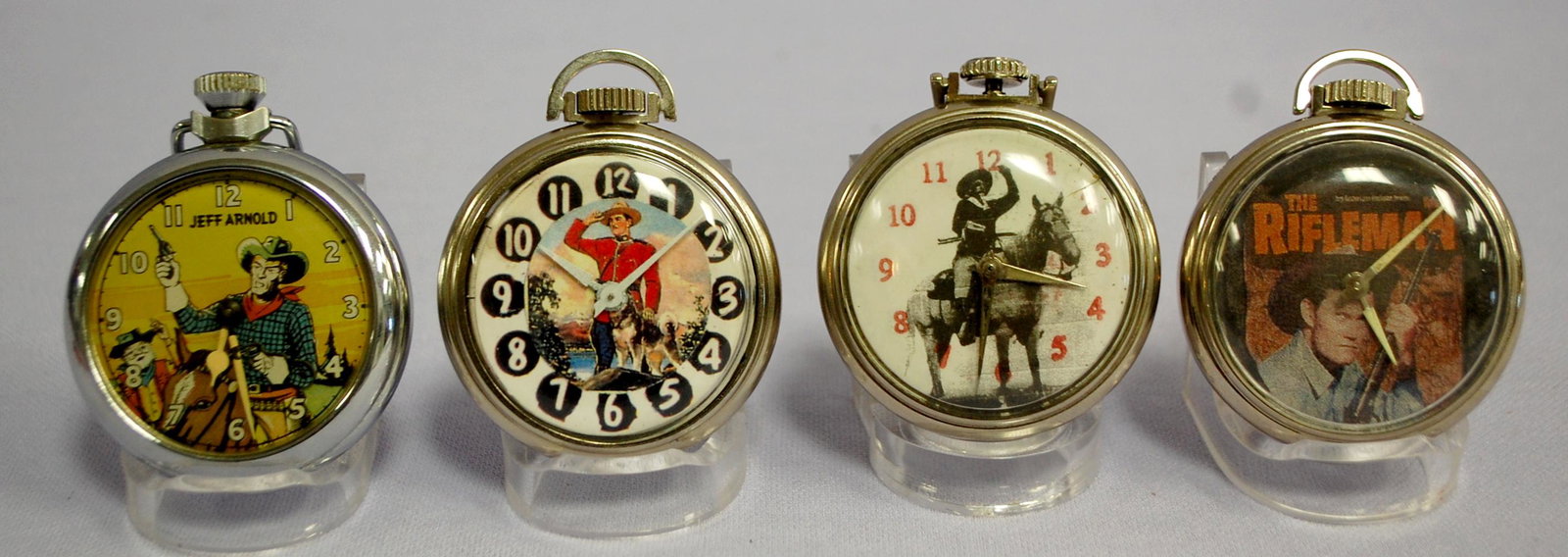 4 Character Dial Pocket Watches: 4 Character Dial Pocket Watches. 1- Jeff Arnold- Made in Great Britain- cowboy with guns drawn. Not running. Clean. 2- Srgt Areston and dog- Made in U.S.A, clean and running. 3- Buffalo Bill on dial, 