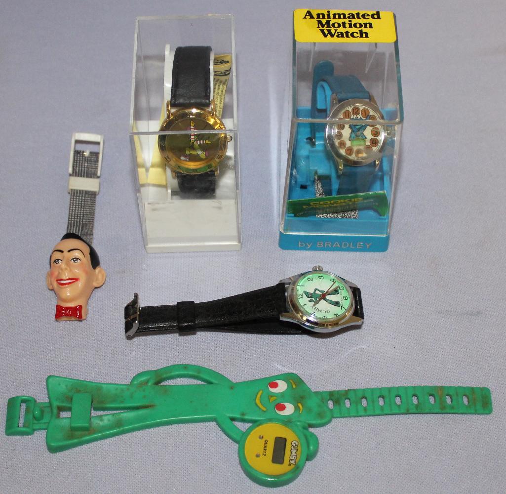 Lot of 5 Vintage Cartoon Wrist Watches: Lot of 5 Vintage Cartoon Wrist Watches. 1- Cookie Monster animated in box 2- Ronald McDonald animated in box. 3- 2 Gumby wrist watches, quartz and manual wind. 4- 1 Peewee Herman quartz **All watches 