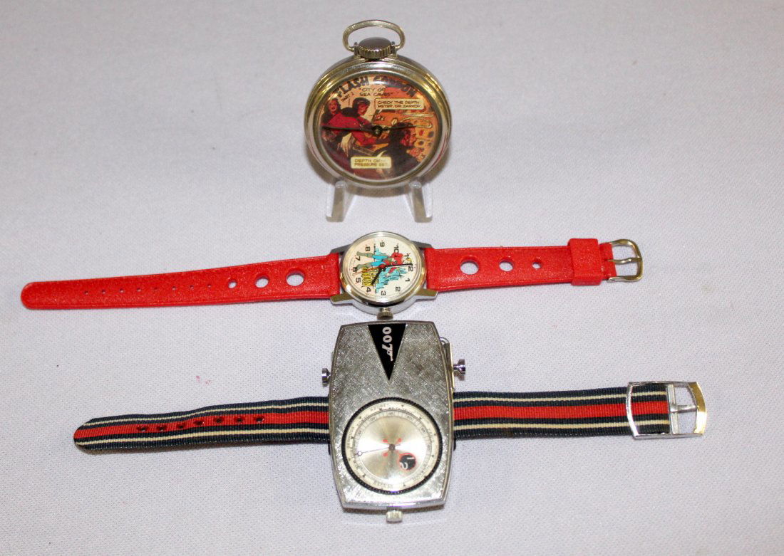 Flash Gordon Pocket Watch & Wrist Watch: Flash Gordon Pocket Watch & Wrist Watch, and 007 Wrist Watch. 007 wrist watches is by Gilbert. 007 watch shows World Time- not running. Flash Gordon pocket watch- City of Sea Caves dial. Made in USA-