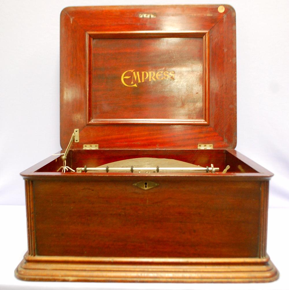 Antique Empress 12" Disc Music Box: Antique Empress 12" Disc Music Box: manufactured in late 1800's, mahogany case, good condition, comes w/ 17 discs. 9 1/2" x 21" x 18" **This clock is FOB which means shipping is ENTIRELY the buyer's r
