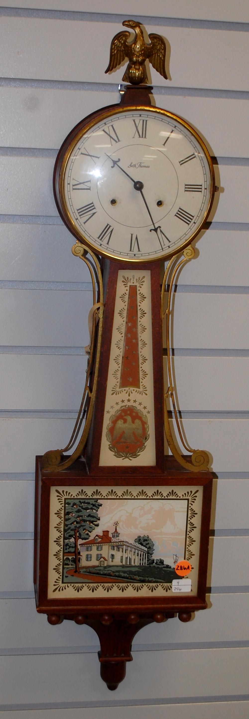Antique Seth Thomas Mahogany Banjo Clock: Antique Seth Thomas Mahogany Banjo Clock: signed dial, signed T&S movement, mahogany case, decorated glass, eagle finial, brass trim. 32" x 8"