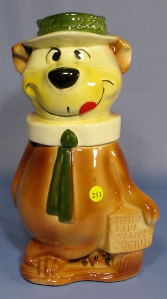 Yogi Bear Cookie Jar: Yogi Bear Cookie Jar: "Better Than Average Cookies". Marked on back Hanna-Barbera 1961 Productions USA. (Inner lid rim chips and crazing.) 13 1/4" tall All items sell As Is, Where Is, no guarantees of