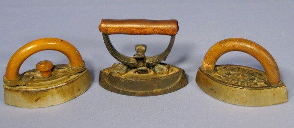 3 Cast Iron Child's Sad Irons: 3 Cast Iron Child's Sad Irons: 1.) "The Pearl" with wood handle. 2.) 2 with detachable wood handles, no marks. No condition problems. All are 4" tall All items sell As Is, Where Is, no guarantees of a