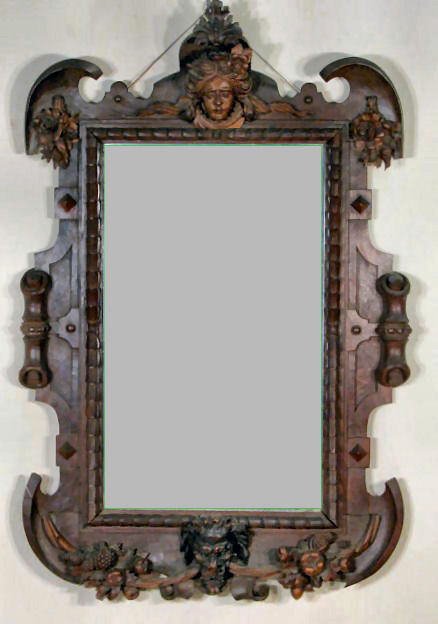 Victorian Black Forest Carved Mirror Frame: Victorian Black Forest Carved Mirror Frame: on top is a ladies head and flowers. The sides are notched and have large scrolls on the outer edge. The bottom has a lions head with a rope of fruit throug