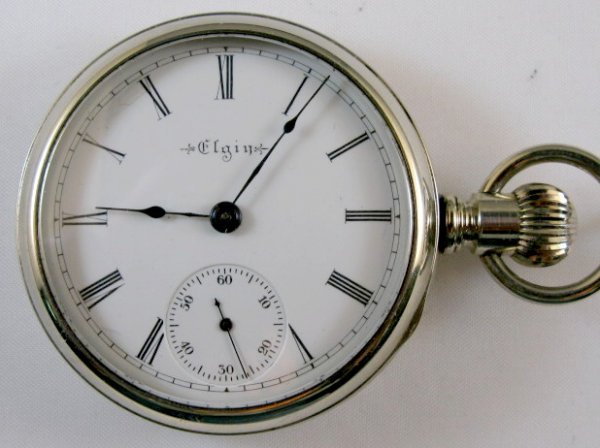 Elgin 17J 18S Display Case Pocket Watch: Elgin 17J 18S Display Case Pocket Watch: open face, lever set. No.9312770, in an unmarked display case. (The dial has some small edge chips and a fracture between 10 and 11.) 2 1/16" wide and running 