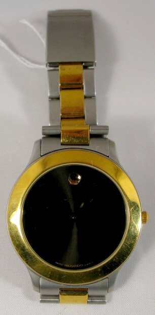 Movado Museum Model Wrist Watch: Movado Museum Model Wrist Watch: quartz movement serial no.4045582. Swiss made, 17J, date at 12 o'clock. Battery operated, not tested. With a stainless steel linked band. (The gold colored bezel has b