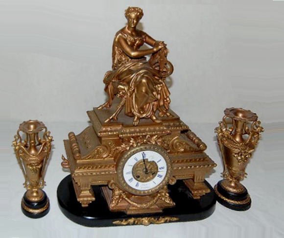 3 Pc French Marti Industry Garniture Clock Set: 3 Pc French Marti Industry Garniture Clock Set: time and bell striking movement with a 4" porcelain dial. The figure on top holds some geared wheels; made of white metal on a wood base. (Both springs 
