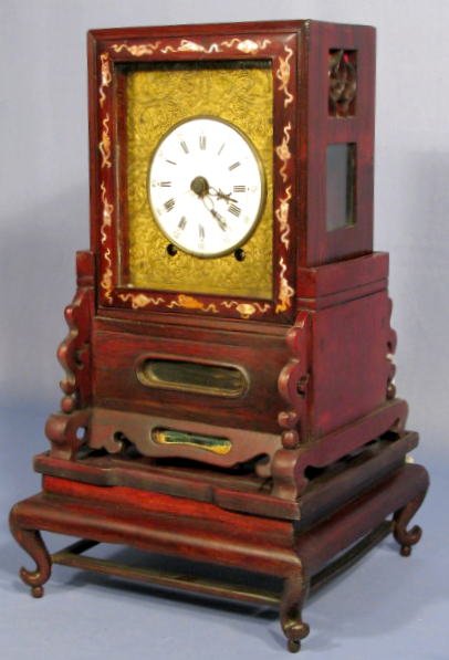 Japanese Bracket Clock- Double Fusee: Japanese Bracket Clock- Double Fusee: in a mother of pearl inlaid rosewood case and stand made in 3 pieces. The brass front has intricate designs of bats, scrolling leaves and sign of longevity. The p