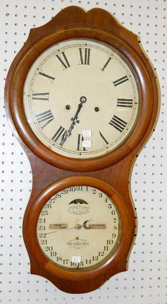 Ithaca No. 4 Hanging Office Calendar Clock: Ithaca No. 4 Hanging Office Calendar Clock: Walnut cased 30 day time and strike movement with a 12" time and a 9" calendar dial. (The dials have some slight discoloration.) 28 1/2" T All items sell As