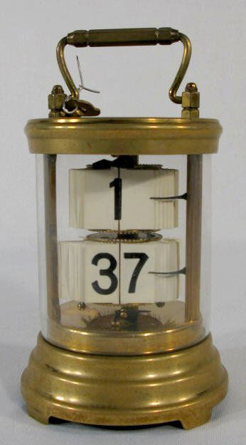 The Plato Clock w/Glass Body: The Plato Clock w/Glass Body: the brass case is marked and it has a removable key winder. (Not running. The gilt finish is worn away.) 5 7/8" tall All items sell As Is, Where Is, no guarantees of any