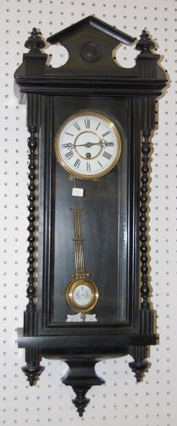 Ebonized German RA Regulator Clock: Ebonized German RA Regulator Clock: w/turned columns. Time only spring wound movement with a 5 1/2" porcelain dial. The RA pendulum is with it. (Broken suspension) 34 1/2" T All items sell As Is, Wher