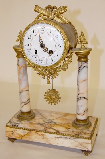 French Vincenti & Cie Marble Column Clock: French Vincenti & Cie Marble Column Clock: silk string suspension with a time and bell striking movement. Dated 1855 with a floral 4" dial; 2 columns. Working at this time. Strikes on the half hour. (