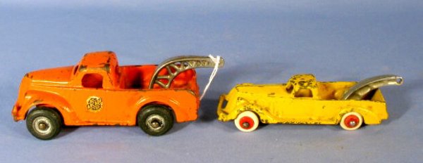 2 Cast Iron Toy Wreckers: Arcade & Hubley: 2 Cast Iron Toy Wreckers: 1.) The Arcade is orange, is signed and has a sticker on the drivers door. 6 1/4" long 2.) The Hubley is yellow with a similar lift in the back. It is signed. 5 1/2" long (Bo
