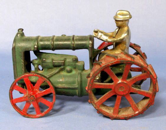 Arcade Fordson Tractor w/Driver Cast Iron Toy: Arcade Cast Iron Fordson Toy Tractor w/Driver: painted green with red metal wheels. Circa 1922-23. Not marked. (The wheels are wobbly. The paint is worn.) 5 3/4" long All items sell As Is, Where Is, n