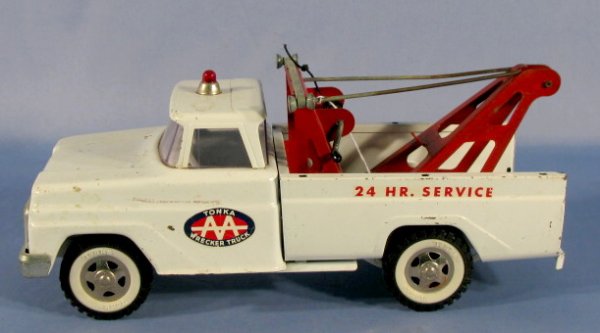 "Tonka Toy AA Wrecker Truck, 24 Hr. Service": "Tonka AA Wrecker Truck, 24 Hr. Service": white and red steel, with white wall Tonka tires. (Slight paint loss, corrosion on grill.) 14" long All items sell As Is, Where Is, no guarantees of any kind.