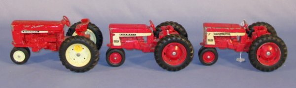 Group of 3 Old International Toy Tractors: Group of 3 USA Toy Tractors: with plastic wheels. 1.) Farmall 404 2.) International 404 3.) International (All have paint loss.) All are 8" long All items sell As Is, Where Is, no guarantees of any ki