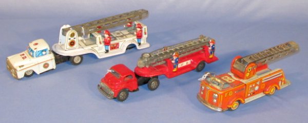 Group of 3 Tin Fire Ladder Trucks: Group of 3 Tin Fire Ladder Trucks: Japan (All show corrosion, 1 is missing back wheels.) Largest is 13" All items sell As Is, Where Is, no guarantees of any kind. We accept Mastercard & Visa, no paypa