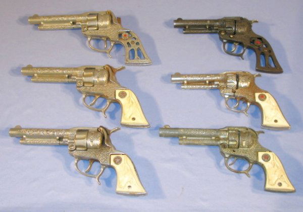 Group of 6 Texan Cap Guns: Group of 6 Texan Cap Guns: 1.) 1 without grips and thumb 2.) 1 missing 1 grip 3.) 1 without grips 4.) 3 Texan Jr. cap guns (All show use.) All items sell As Is, Where Is, no guarantees of any kind. We