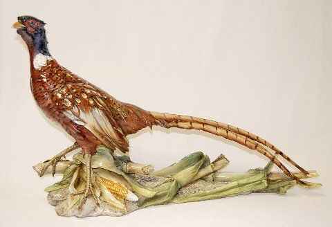 Life Size Ceramic Rooster Pheasant Statue: Life Size Ceramic Rooster Pheasant Statue: standing in corn; unmarked; high color, very detailed. (Chip off tip of beak, 1 claw and 1 tail feather.) 19" t x 32" l All items sell As Is, Where Is, no gu