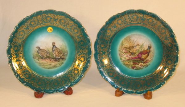 Pair of German Green & Gold Game Plates: Pair of German Green & Gold Game Plates w/Pheasants & Birds: dark geen background with gold decorated edges; center of one is of a hen and rooster pheasant; the other is of a male and female partidge.