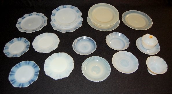 Approx. 23pc Depression Glass Items: Approx. 23pc Depression Glass Items: 1.) 18pc set of Moonstone dinnerware, scroll pattern: 3- 9" plates; 9- 6 1/2" plates; 2 cup saucers; 1 cup; 1- 6" low bowl; 1- 4 1/2" open sugar. 2.) 5 pieces of M