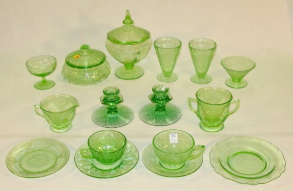 16 pc. Mixed Green Depression Glass Items: 16 pc. Mixed Green Depression Glass Items: 1.) Pair of candlesticks, 4" T 2.) Round covered candy dish, (Chip on inner lid and small chips to inner base rim.) 4 1/2" T 3.) Covered candy dish, (Chip on