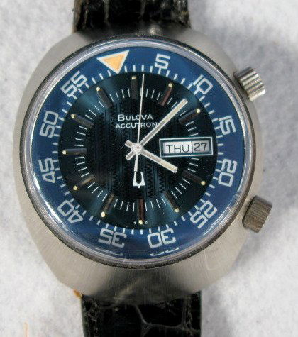 Bulova Accutron N/05 Wrist Watch: Bulova Accutron N/05 Wrist Watch: with center rotating 60 second marker. Blue dial with day and date wheel at the 3. These are estate watches that have been stored for up to 30 years; we found them in