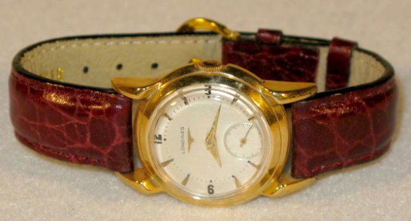 Longines 17J 14K No.8152263 Wrist Watch: Longines 17J 14K No.8152263 Wrist Watch: unadjusted, marked 23Z. In a yellow 14K snap on case numbered A74724. Silver, round dial with gold hands, numbers and markers. Running at this time. These are