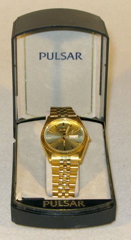 Pulsar Quartz Wrist Watch in Box: Pulsar Quartz Wrist Watch in Box: stainless steel and base metal numbered 645417. Japan made movement. Gold dial with day and date the 3. Not tested. These are estate watches that have been stored for