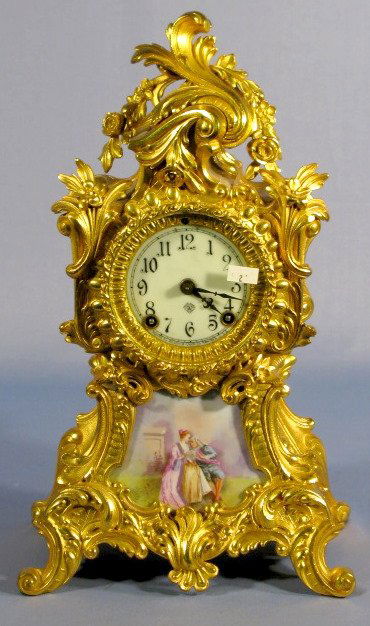 Ansonia Trianon Metal Clock w/Porcelain Insert: Ansonia Trianon Metal Clock w/Porcelain Insert, Courting Couple: porcelain dial, time and strike, rococo case, fully signed. 15" t x 9 1/2" w All items sell As Is, Where Is, no guarantees of any kind.