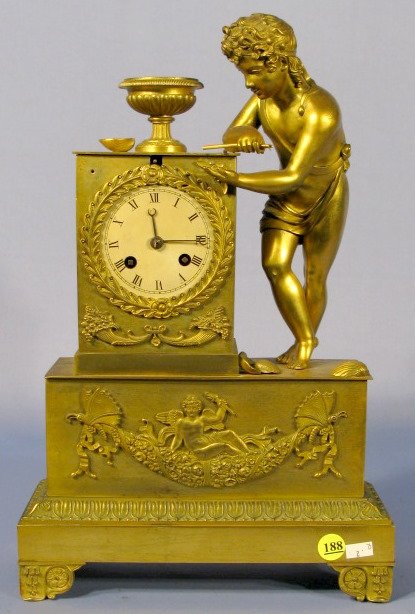 French Empire Silk String Statue Clock: French Empire Silk String Statue Clock: time and strike; boy statue, butterfly, floral and putti applied on front plate. (Some decoration gone, oxidation to patina, bell missing. Needs cleaned.) Runni