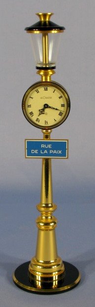 Le Coultre Lamp Post Clock: Le Coultre Lamp Post Clock: Swiss, brass finish with black trim. "Rue Du La Paux" sign. Running at this time. 11" tall All items sell As Is, Where Is, no guarantees of any kind. We accept Mastercard &