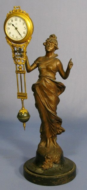 Junghans Germany Swing Clock: Junghans Germany Swing Clock: art nouveau style with fixed key wind movement and 1 3/4" dial. (The metal finish is worn in some places.) 13 3/4" tall and running at this time All items sell As Is, Whe