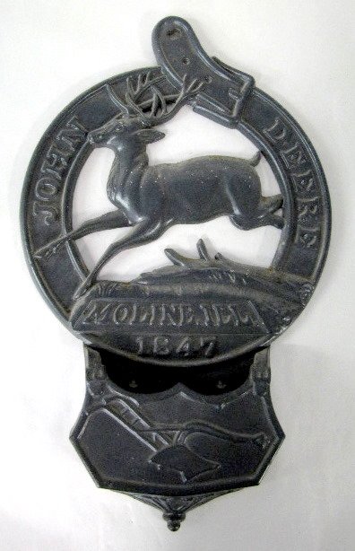 John Deere Cast Iron Wall Hanger: John Deere Cast Iron Wall Hanger: a running deer is inside a buckled belt with this wording- "John Deere Moline, ILL 1847". Below that is a small pocket with a single bottom plow emblem. The back has 