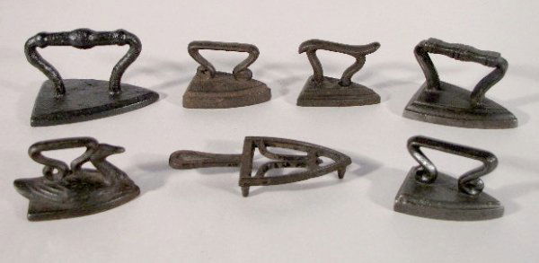 6 Cast Iron Toy Sad Irons & 1 Trivet: 6 Cast Iron Toy Sad Irons & 1 Trivet: 1.) Swan, 2 5/8" 2.) With fancy handle, 2 1/8" 3.) With horizontal lines on the handle, 2 5/8" 4.) Very flat with round knobby handle, 3 3/16" (The paint is over