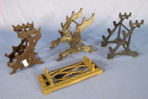 4 Cast Iron Pen Stands: 4 Cast Iron Pen Stands: 1.) Flat and held 3 pens, 5 3/4" 2.) Held 5 pens, 4 1/2" 3.) Held 4 pens, 4 3/4" 4.) Held 4 pens and is designs to have a now missing glass ink bottle, 4". No cracks or breaks.