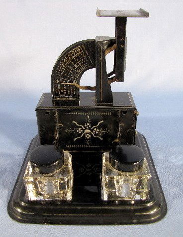 Reliance Postal Scale w/Ink Jars: Reliance Postal Scale w/Ink Jars: made of decorated tin with 2 drawers on one side and the 2 pressed glass ink jars in front. All original with minimal wear. The scale goes to 8 ounces. A pen rack is