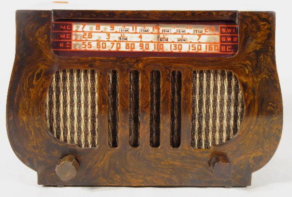 Dewald Model A-501 Catalin Radio, Table Model: Dewald Model A-501 Catalin Radio, Table Model: upper front slide rule dial. Lower cloth grill with 5 vertical bars. 2 knobs and 5 tubes. Described as a harp shape, circa 1946. It picks up some station