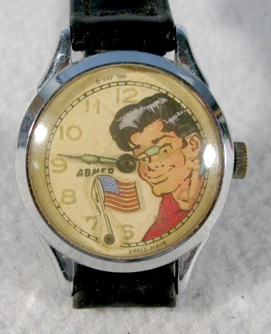 Lil' Abner Wrist Watch w/Moving Flag: Lil' Abner Wrist Watch w/Moving Flag: Swiss made, he is shown on the dial looking at the flag. (Not running.) All items sell As Is, Where Is, no guarantees of any kind. We accept Mastercard & Visa, no