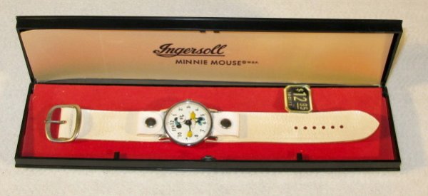 Ingersoll Minnie Mouse Wrist Watch in Box: Ingersoll Minnie Mouse Wrist Watch in Box: she is on the dial using her arms as time indicators. Attached is a wide, white snap on leather band. Made for W.D.P. New in box. (There is no seconds bit.) 