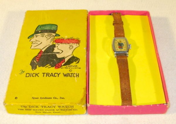 New Haven Dick Tracy Wrist Watch in Box: New Haven Dick Tracy Wrist Watch in Box: made for News Syndicate Co. He is shown on the gold dial pointing his gun along with his name. Looks excellent. (The box top has a few problems, but is complet