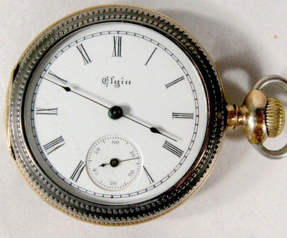Elgin 7J 0S Grade 173 Pocket Watch: Elgin 7J 0S Grade 173 Pocket Watch: 1898, serial #7,037,400, Philadelphia Sterling case, engraved on the back with gold inlay. No condition problems. 1 1/2" wide and running at this time. All items se