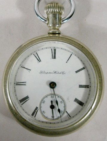 Hampden Gladiator 9J 18S Pocket Watch: Hampden Gladiator 9J 18S Pocket Watch: serial #790090, lever set, open face Fahys ore silver case. (Crystal scratches.) 2 3/16" wide and running at this time. All items sell As Is, Where Is, no guaran