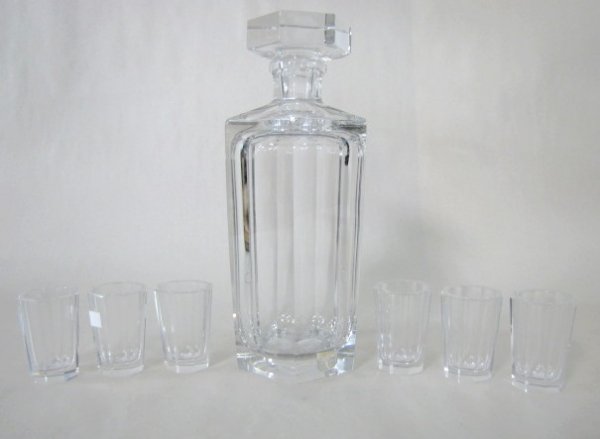 7pc Kosta Clear Liquor Set: 7pc Kosta Clear Liquor Set: the decanter, with stopper and the 6 glasses all have 6 panels. The decanter is 9" tall and numbered 15x8, has a bad sticker. The glasses arr 2 3/16" tall. (The decanter ha