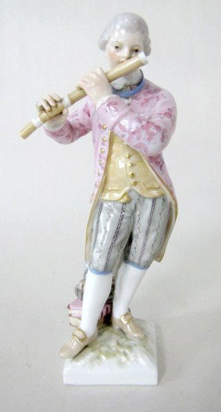 KPM Porcelain Fife Player, Circa 1830: KPM Porcelain Fife Player, Circa 1830: marked in red KPM with an orb and cross above it. The male figure is dressed in colonial style clothing with a stack of books behind him. (Has a small amount of