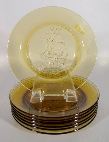 7 Amber Glass Plates w/Sailing Ships: 7 Amber Glass Plates w/Sailing Ships: they all have the same Columbus era style ships in the center. No condition problems. 8 5/8" wide All items sell As Is, Where Is, no guarantees of any kind. We ac