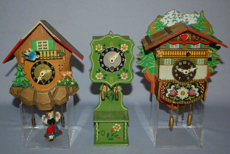 Lot of (3) Pendulette 2 Wall & 1 Mantle Style: Lot of (3) Pendulette 2 Wall & 1 Mantle Style. 1.) Heco swinging women with animated bird 7"x5". 2.) German mountain cabin with scene weights & pendulum. 7"x6". 3.) German open well, tall case style.